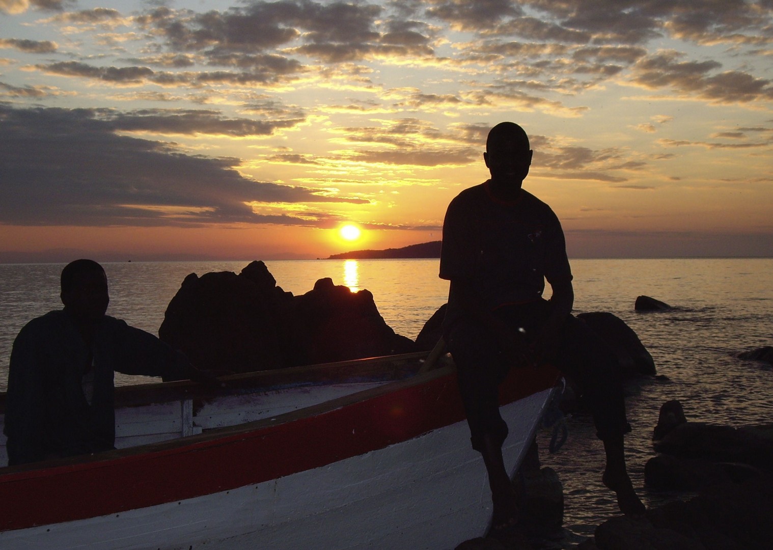 Sunset by the boats on Lake Malawi - Malawi - Meet the People Tours